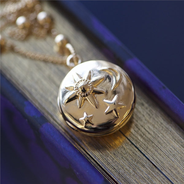 NEWBRIDGE SILVERWARE GOLD PLATED LOCKET WITH SUN MOON & STARS